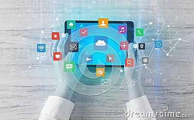 Hand using multitask tablet with application symbols and icons concept Stock Photo