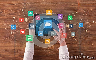 Hand using multitask tablet with application symbols and icons concept Stock Photo