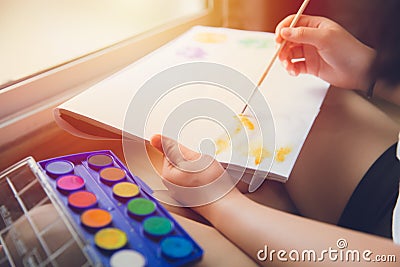 Hand using paint brush to draw water color painting for hobby at home Stock Photo