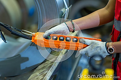 Hand using remote control overhead cranes remote. Foreman or worker using remote control machine at factory site Stock Photo