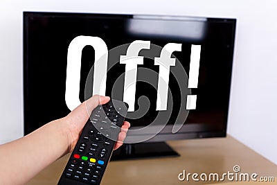 Hand using a remote control to turn off the TV with an OFF text Stock Photo