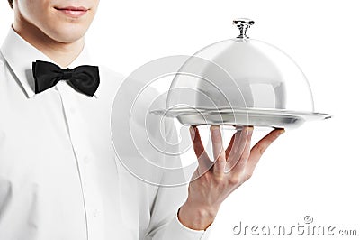 Hand of waiter with cloche lid Stock Photo