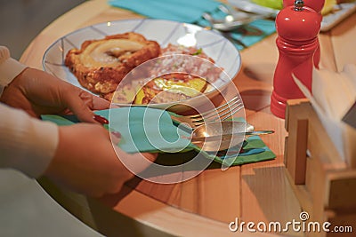 Hand of waiter serving dinner at restaurant. Healthy dinner. Eating out in restaurant. Waiter in uniform at work. Stock Photo