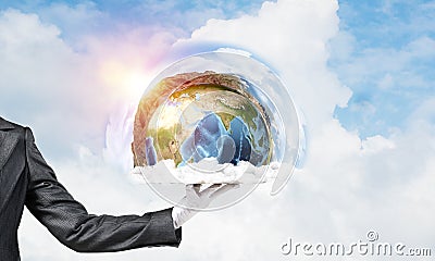 Hand of waitress presenting Earth globe on tray. Stock Photo