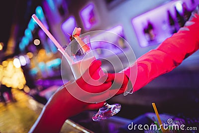 Hand of waitress serving cocktail Stock Photo