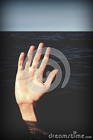 Hand on the sea of a person who is drowning and seeks help Stock Photo