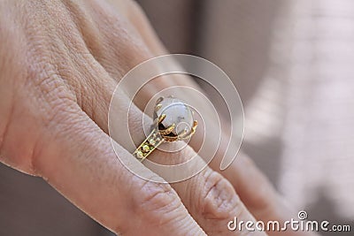 hand wearing brass ring with shiny moonstone gemstone Stock Photo