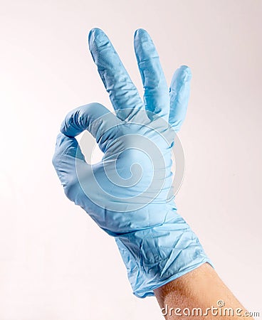 Hand wearing PPE signing OK Stock Photo