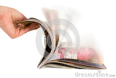 Hand which is thumbing magazine Stock Photo