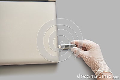 Hand in white glove insert usb flash disc. Stock Photo