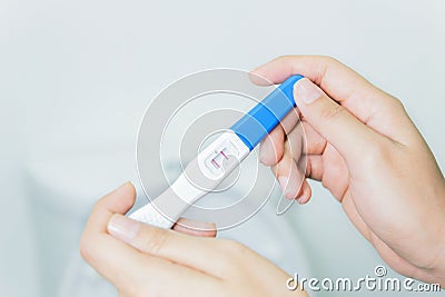 Hand Woman checking pregnancy test Stock Photo