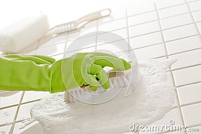 Hand of woman cleaning bath tiles Stock Photo