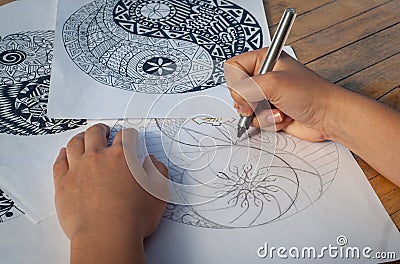 Hand of woman drawing yin yang for anti stress coloring book Stock Photo