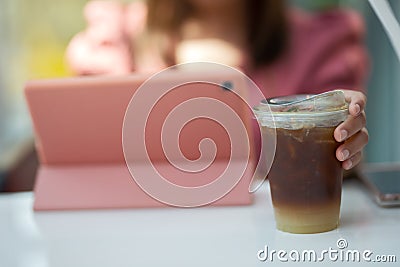 Hand woman holding the glass iced coffee Stock Photo