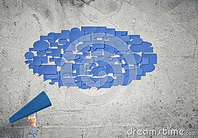 Hand of woman holding green paper trumpet and speech cloud coming out Stock Photo