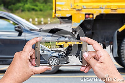 Hand of woman holding smartphone and take photo of car accident Editorial Stock Photo