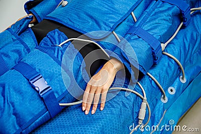 Hand of woman lying down during pressotherapy treatment Stock Photo