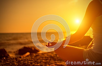 Hand of woman meditating in a yoga on beach Stock Photo