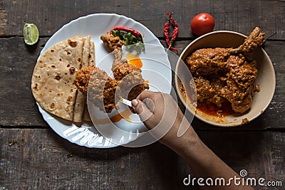 Hand of woman serving cooked food on a plate Stock Photo