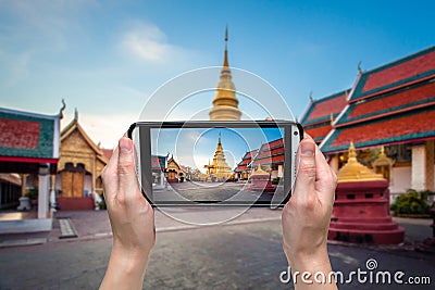 Hand woman taking photo at wat phratad haripunchai in lamphun Stock Photo