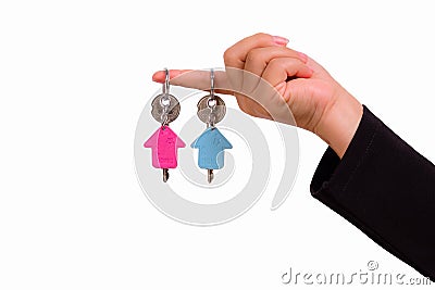 Hand of woman with two keychain in the shape of the house Stock Photo