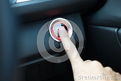 Hand of woman using finger for press start engine button with li Stock Photo