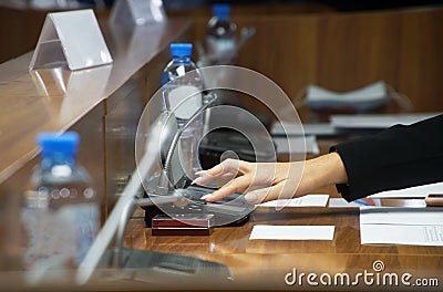 Hand of a woman voting during a political meeting. Parliamentary lawmaking Stock Photo