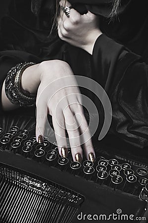 Hand of a woman writing at a typewriter Stock Photo