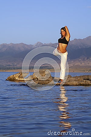Hand woman yoga and natarajasana pose meditation and relax in the mountan lake. Healthy and Zen Concept Close up Stock Photo