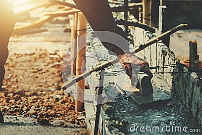 hand worker leveling concrete for mix cement at construction Stock Photo