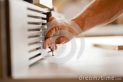Hand working with a wood shaper Stock Photo