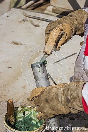 Hand of a workman filling grease gun Stock Photo