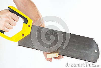 Hand of workman sawing wooden block with hacksaw Stock Photo