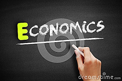Hand writing ECONOMICS on blackboard, business concept Stock Photo