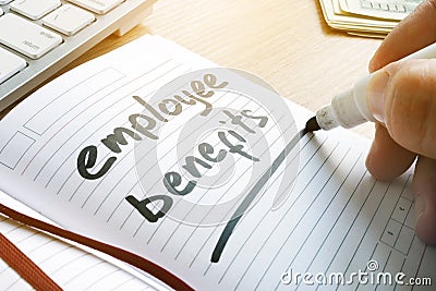 Hand is writing Employee benefits. Stock Photo