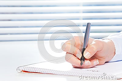 Hand writing with fountain pen at the table Stock Photo