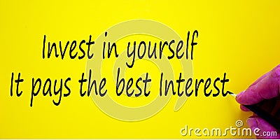 Hand writing `invest in youpself it pays the best interest`, on yellow background. Business concept Stock Photo