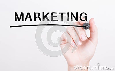 Hand writing MARKETING with black marker on transparent wipe board Stock Photo