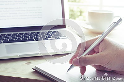 Hand writing on notebook with laptop.Inspiration moment Stock Photo