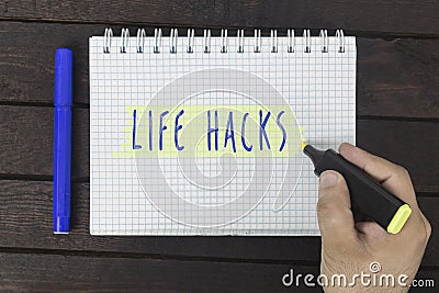 Hand writing on notepad: Life hacks Stock Photo