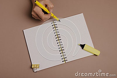 Hand writing in notepad using a pen, on gray background Stock Photo