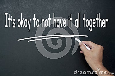 Hand writing It is okay not to have it all together affirmation on black board. Affirmation concept. Stock Photo