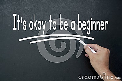 Hand writing It is okay to be a beginner affirmation on black board. Affirmation concept Stock Photo