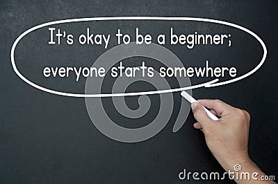 Hand writing It is okay to be a beginner affirmation on black board. Affirmation concept. Stock Photo