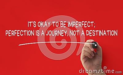 Hand writing It is okay to be imperfect affirmation on red cover background. Affirmation concept. Stock Photo