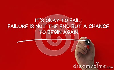 Hand writing It is okay to fail affirmation on red cover background. Affirmation concept. Stock Photo