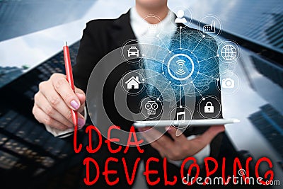 Hand writing sign Idea Developing. Business idea innovating the concept and bringing the idea to reality Lady In Uniform Stock Photo