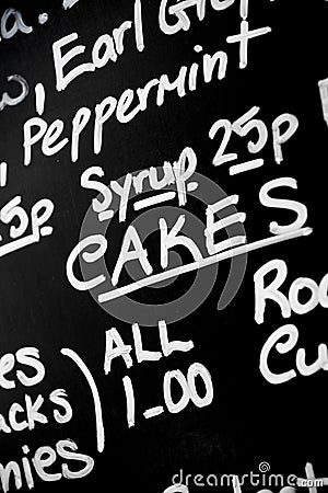 Hand written chalk menu board featured the word Cakes prominently Stock Photo