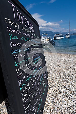 Hand Written Menu On Beach Outside Greek Taverna Stock Photo
