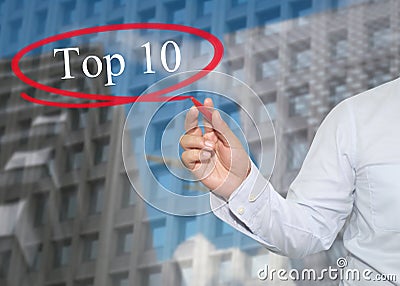 Hand of young businessman write the word Top 10 on skyscrapers Stock Photo
